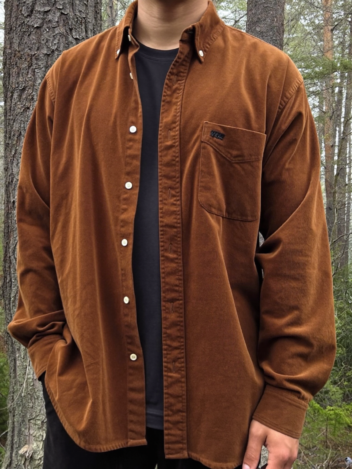 Man wearing a bark brown heavyweight brushed cotton flannel shirt in a misty forest
