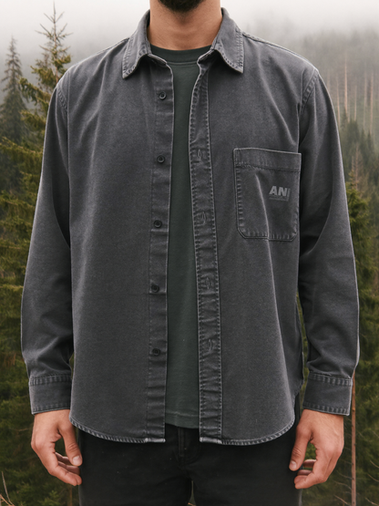 Man wearing a charcoal grey heavyweight brushed cotton flannel shirt in a misty forest